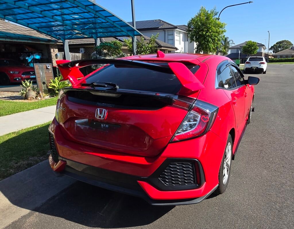 Honda Civic FK7 RS Hatchback red and gloss black Type R style spoiler installed rear view