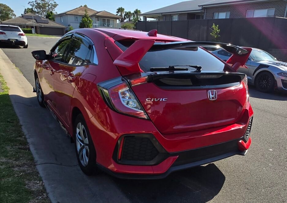 Honda Civic FK7 RS Hatchback red and gloss black Type R style spoiler installed Side view