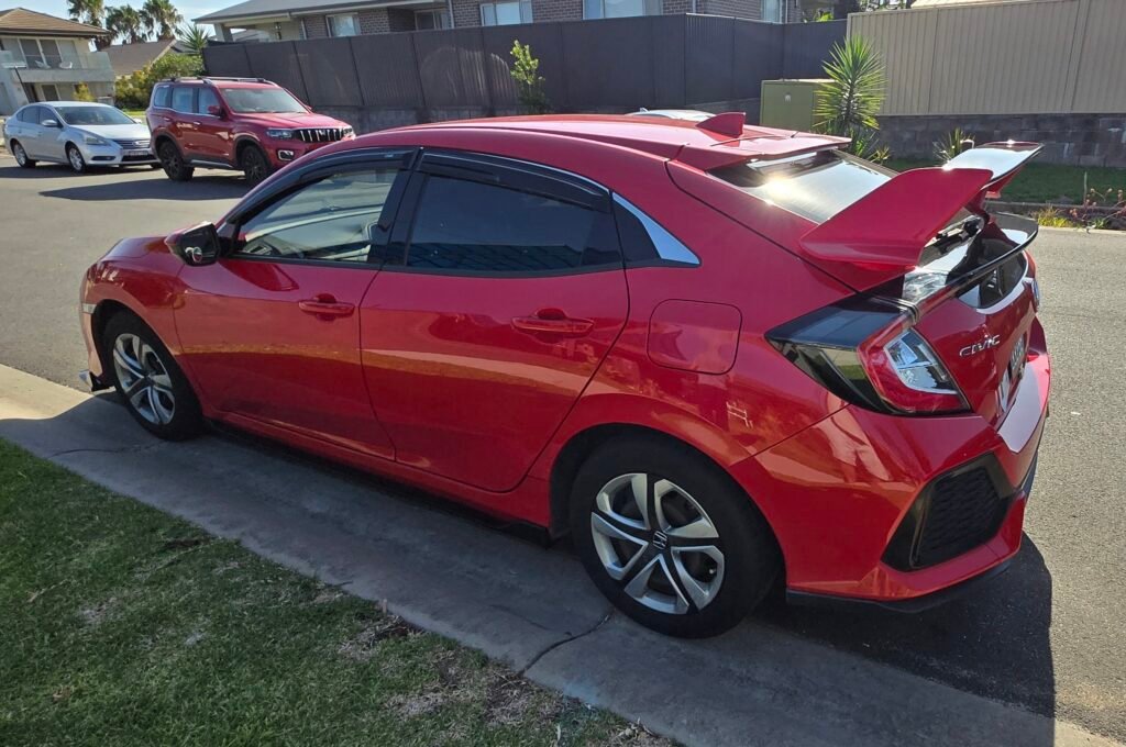 Honda Civic FK7 RS Hatchback red and gloss black Type R style spoiler installed Side view