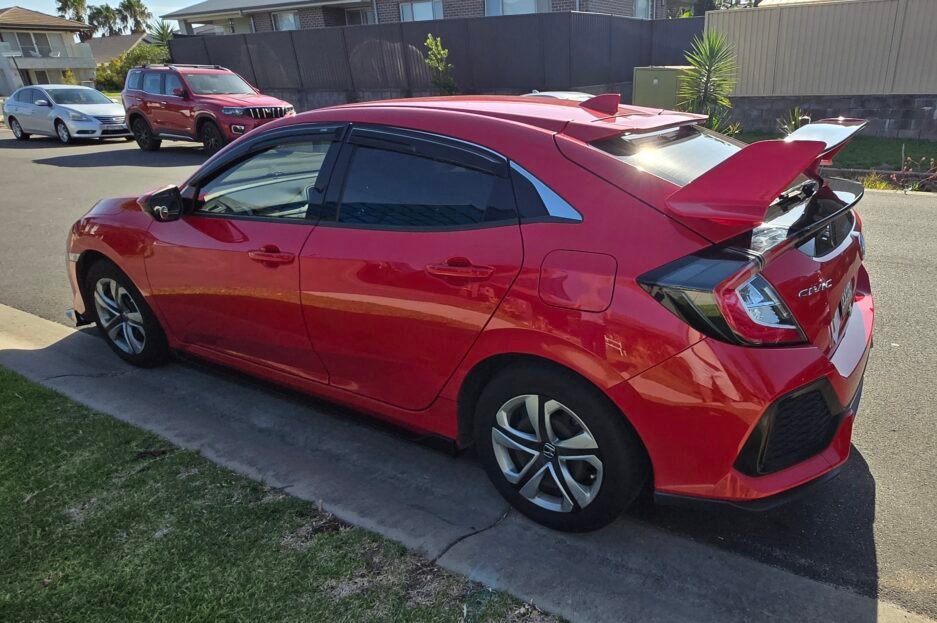 Honda Civic FK7 RS Hatchback red and gloss black Type R style spoiler installed Side view