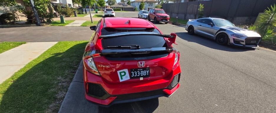 Honda Civic FK7 RS Hatchback red and gloss black Type R style spoiler installed rear view